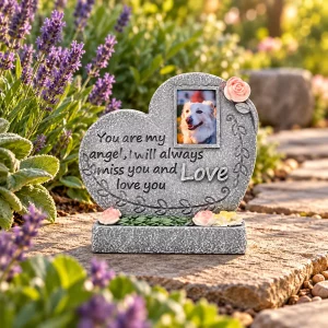 Angel Heart pet memorial plaque, on a flat stone beside a garden path, garden setting