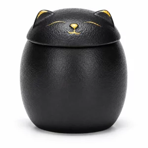 Black ceramic cat urn with gold sleeping face and cat-ear lid