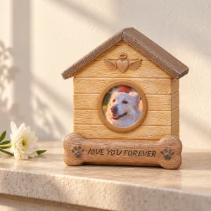 Dog house memorial urn beside a white flower on a sunlit stone shelf