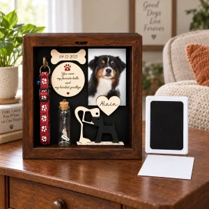 Dog memorial shadow box with paw impression pad and blank card on an indoor table
