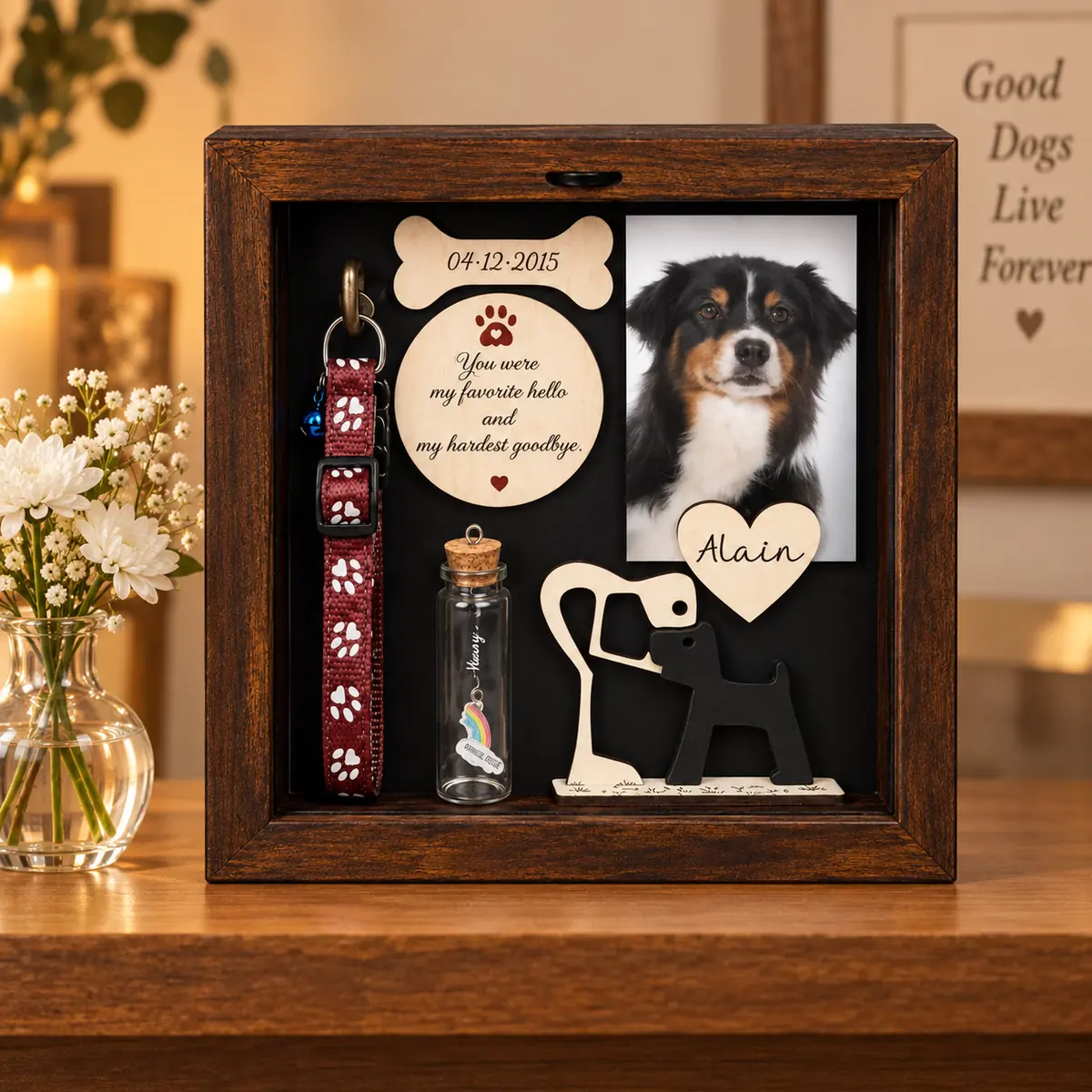 Dog memorial shadow box displayed on an indoor remembrance shelf beside flowers