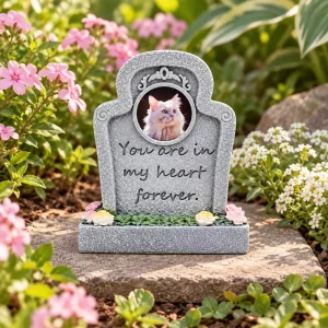 Forever in My Heart pet memorial plaque, on a flat garden paver beside flowers, garden setting