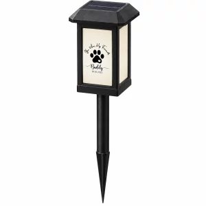 Paw-print solar pet memorial garden light from a slight angle with stake