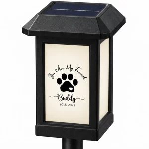 Close view of solar panel and sample paw-print memorial design on garden light