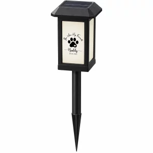 Black paw-print solar pet memorial garden light with full ground stake on a white background