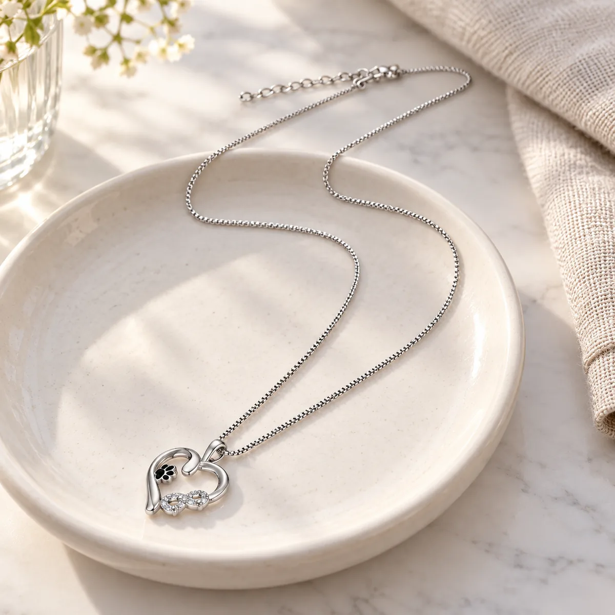 Sterling Silver Heart and Infinity Paw Print Necklace, on a jewelry tray