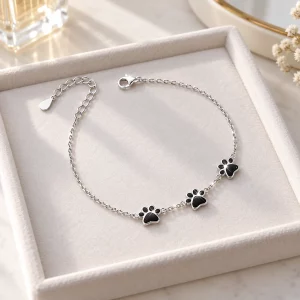 Sterling Silver Three Paw Print Memorial Bracelet, on a jewelry tray