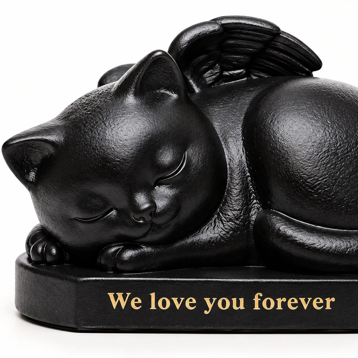 Close view of sleeping cat angel urn with peaceful face and We love you forever inscription