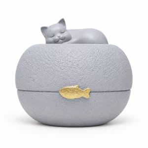 Gray sleeping cat pet urn with a small gold fish accent on the front