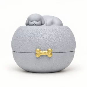 Gray sleeping dog pet urn with a small gold bone accent on the front